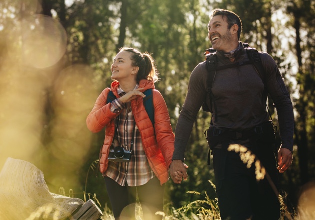 couple enjoying retirement by walking in the woods